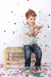 young boy on bench with confetti taken by mini edits photography babyccino kids london shopup