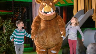 a boy and a girl holding hands with the gruffly