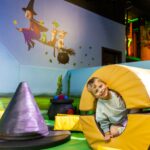 a child inside a soft play tube