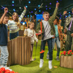 children jumping and cheering at crazy golf