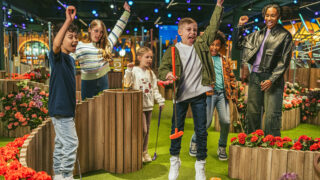 children jumping and cheering at crazy golf